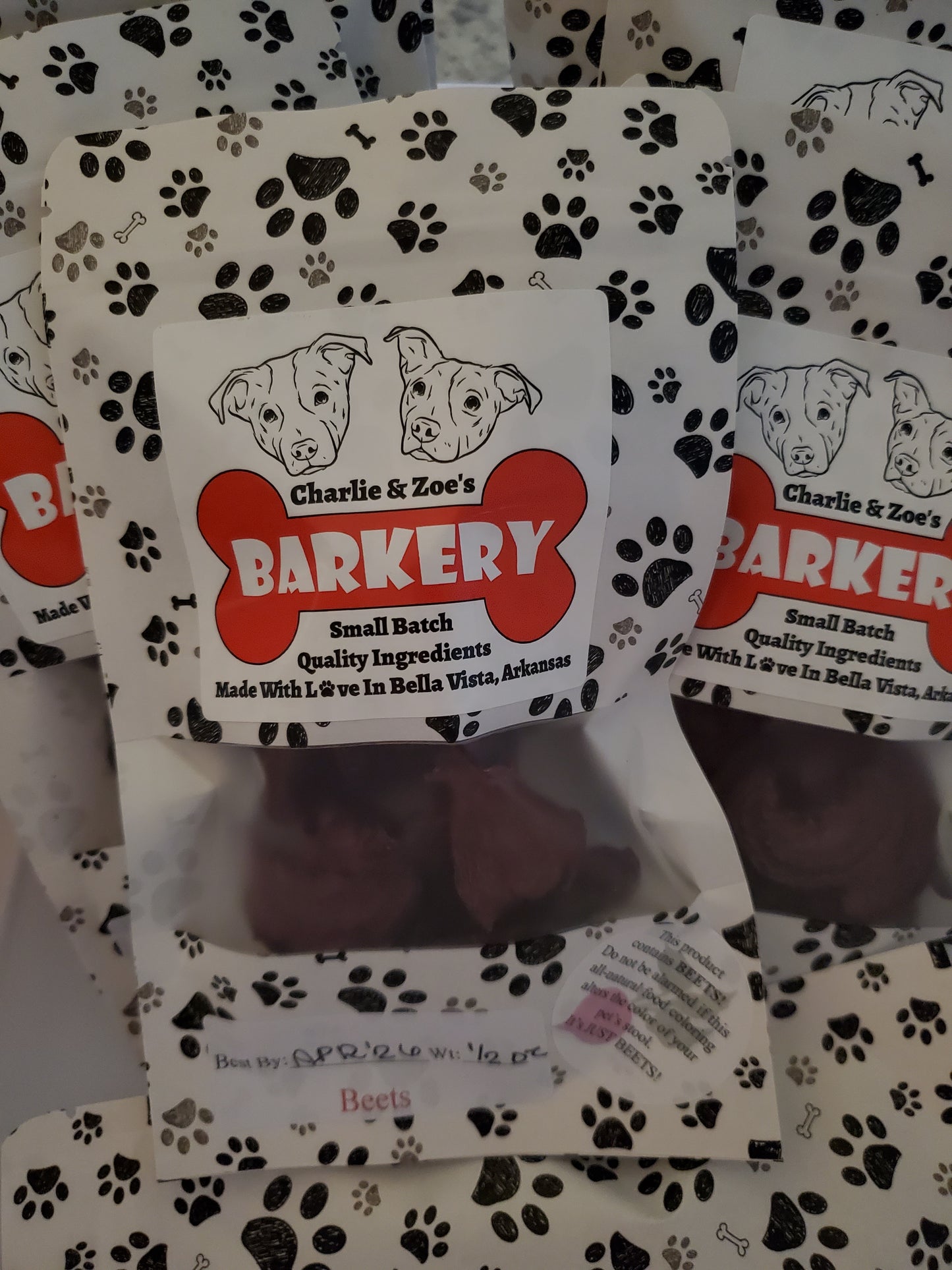 Dog treat packaging with Charlie & Zoe's Barkery branding on a patterned background