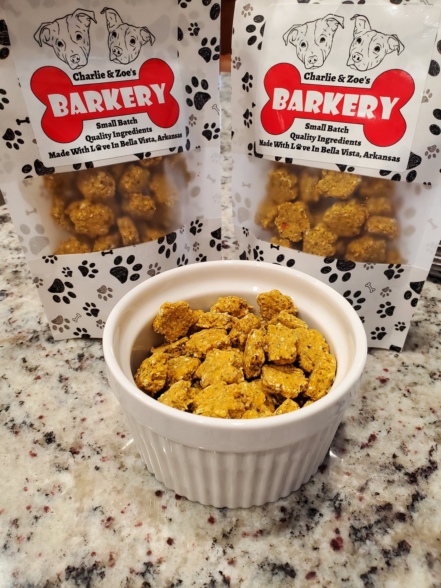 Bowl of cat treats next to Charlie & Zoe's Barkery packaging on a granite countertop