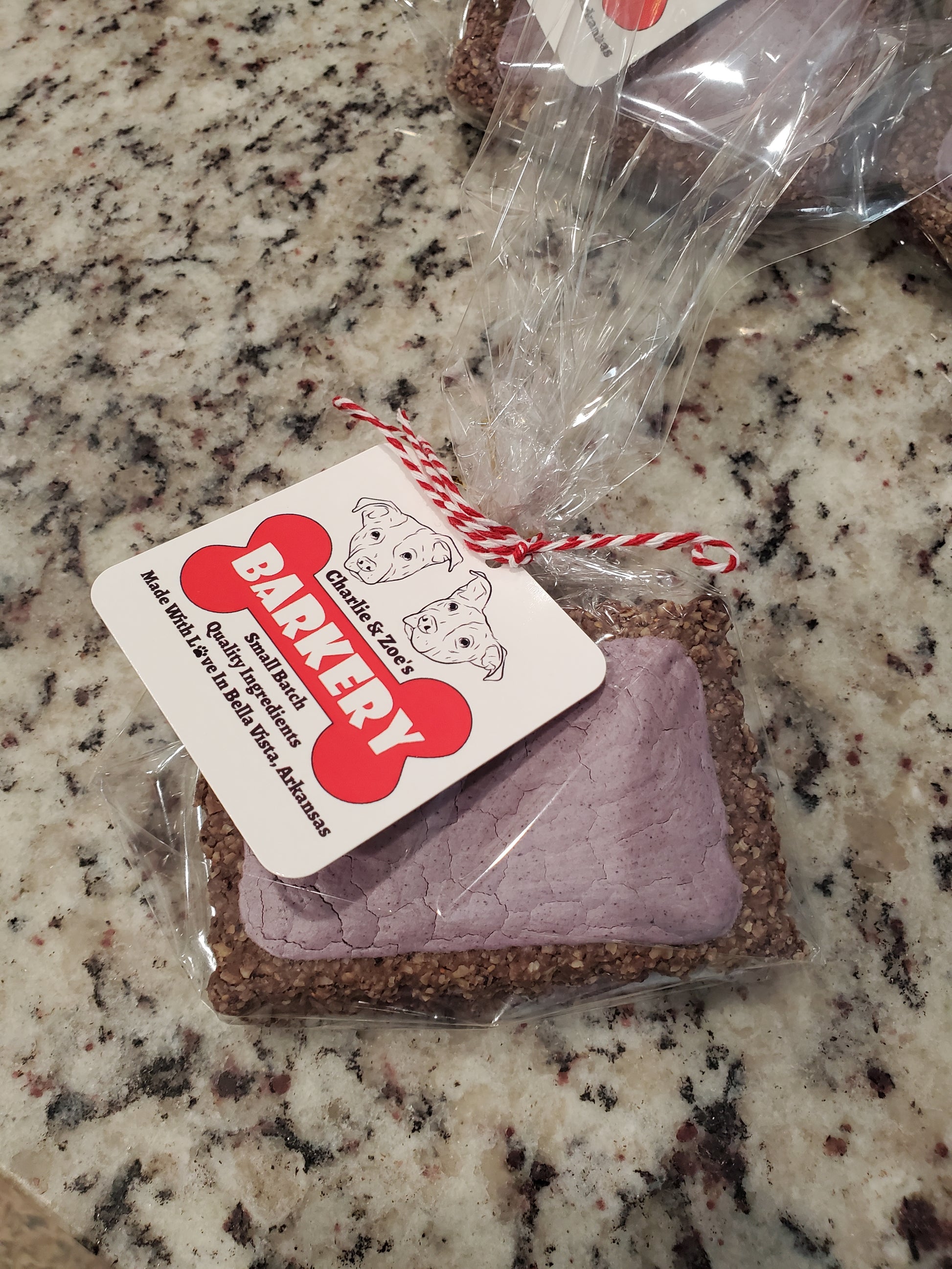 Dog treat package with Charlie & Zoe's Barkery label on a granite countertop