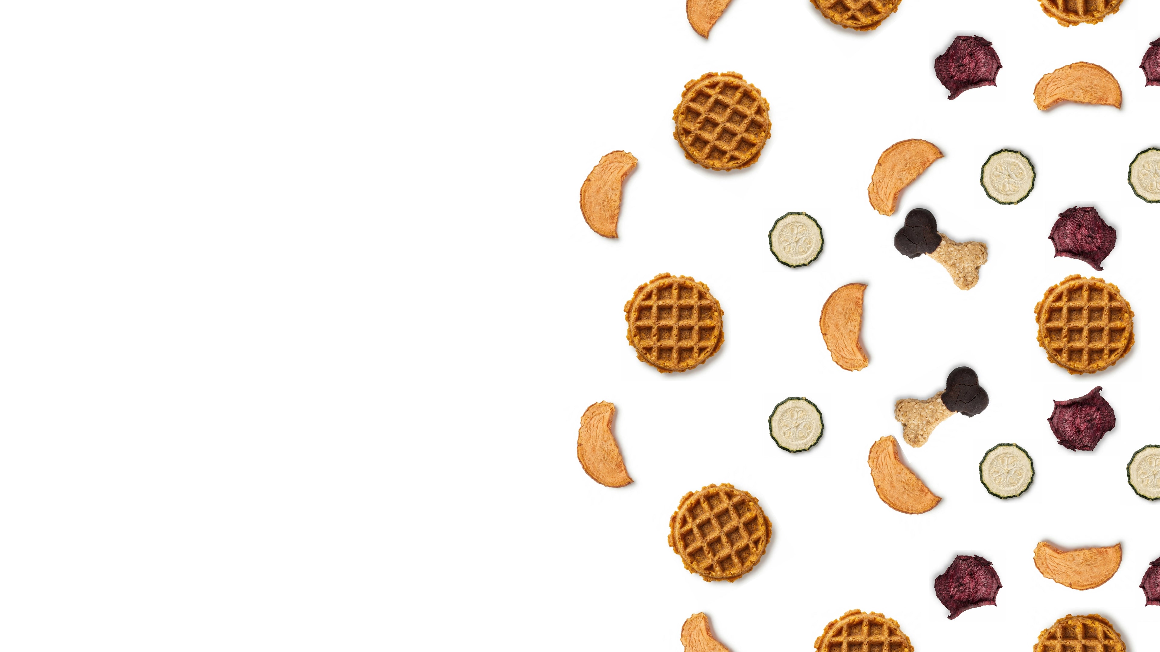 Assorted dog treats on a white background