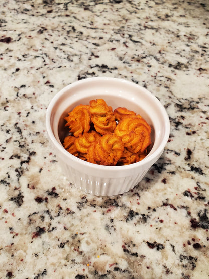 Small white bowl with orange content on a speckled granite countertop
