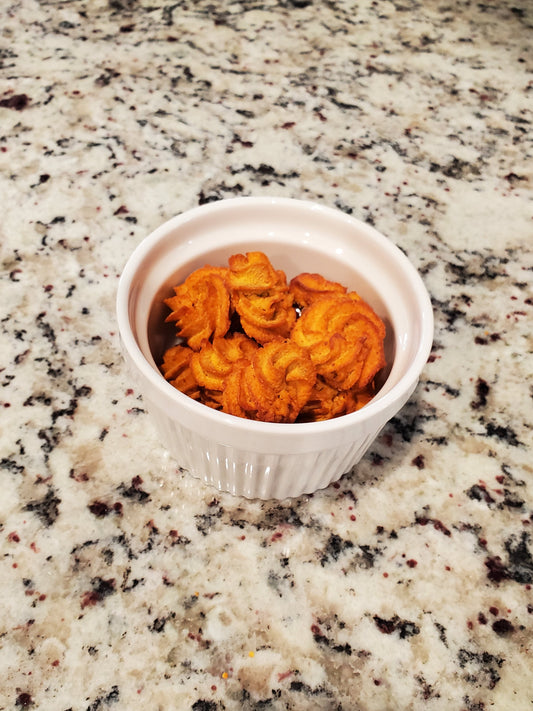 Small white bowl with orange content on a speckled granite countertop