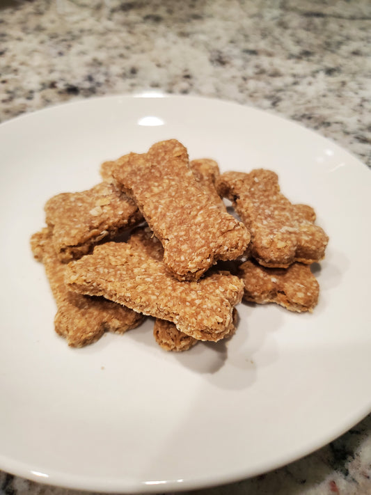 Dog treats shaped like bones on a white plate